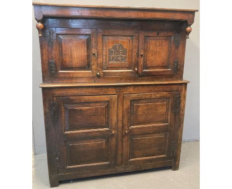 18th century Welsh oak Deuddarn, the moulded cornice with drop finials and two doors with central carved panel 'I T E  1743',