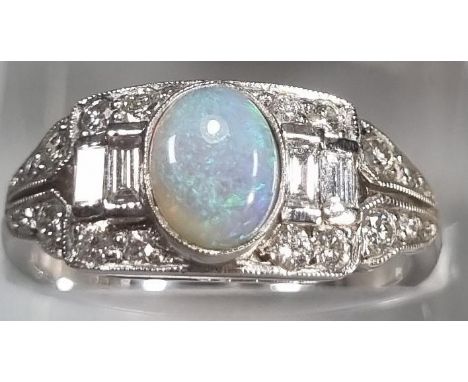 18ct white gold Art Deco style ring with central oval opal surrounded by baguette and other diamonds.  4.6g approx.  Ring siz