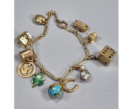 9ct gold charm bracelet with assorted charms including: dice, globe, heart, cottage, bus, bulls's head etc. 17.5g approx. (B.