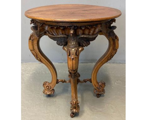 Victorian mahogany and walnut side/lamp table, of circular form, the mahogany moulded top above a walnut frame ornately carve