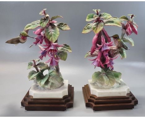 Pair of Royal Worcester ruby throated humming bird figurines on composition Art Deco style stepped bases.  23cm high approx. 