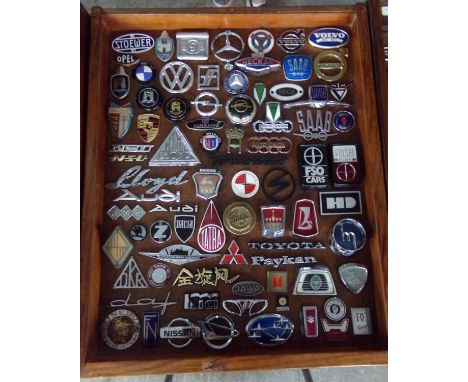 Good case of European and Asian motor vehicle badges, enamel and otherwise, to include: Stoewer, Opel, Mercedes Benz, Volvo, 