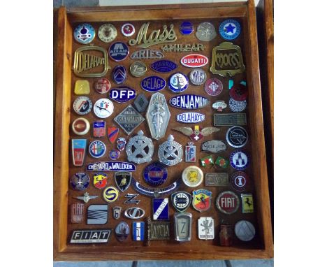 A good glazed case containing assorted French and other European motor car enamel badges, scripts and others, to include: Mas