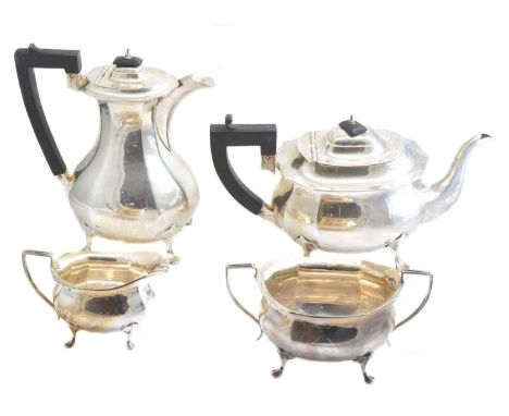 A George V silver four piece teaset, of faceted design with angular handles and raised on four feet, hallmarks for Williams (