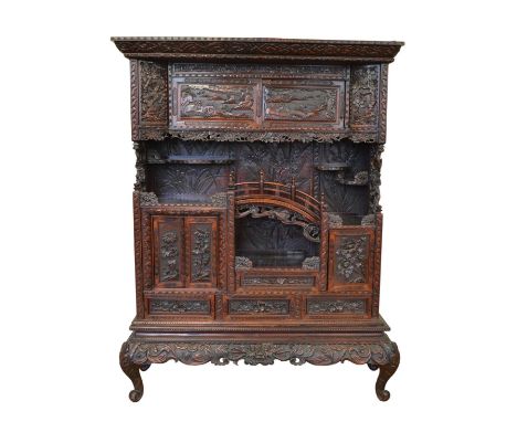 Late 19th-century hardwood display cabinet, the whole cabinet profusely carved with prunus, birds in flight, landscapes with 