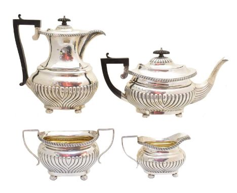 An Edward VII silver four piece tea set, comprising tea pot, hot water jug, milk jug and sugar pot, with half lobed body, gad