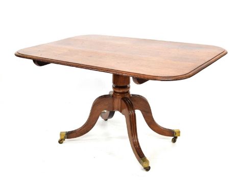 Regency mahogany breakfast table, rectangular top with moulded edge standing on a single pillar with four outswept reeded leg