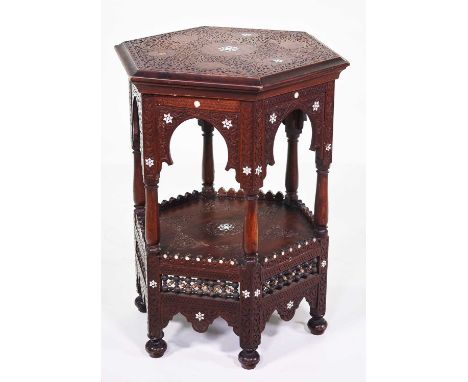 Late 19th-century hardwood Moroccan occasional table, hexagonal top supported on six columns, platform shelf, all over fretwo