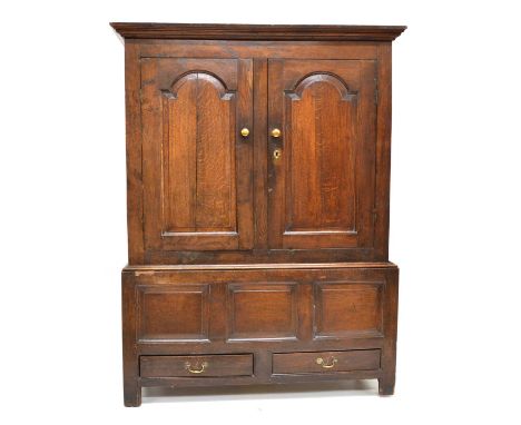 18th-century oak livery cupboard, moulded cornice above two doors each with raised and fielded arched panels, interior with t