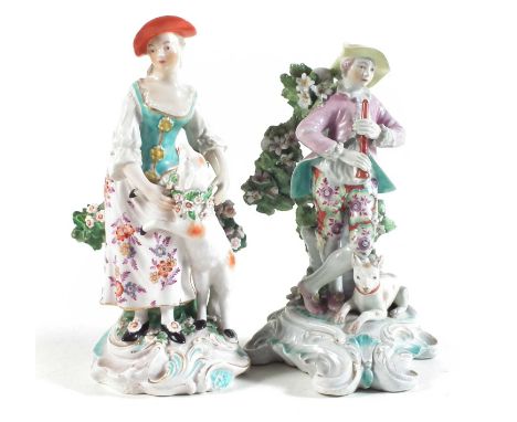 Two Derby figures circa 1770, modelled as a gentleman and lady with sheep and dog, patch marks to bases.  19cm highCondition 