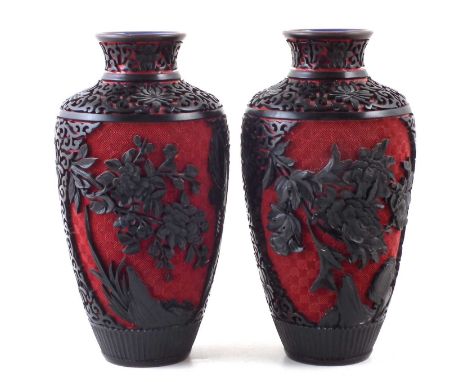 Pair of Chinese Cinnabar Lacquer vases, the finely carved black overlay depicting scrollwork and flowers onto a red ground, b