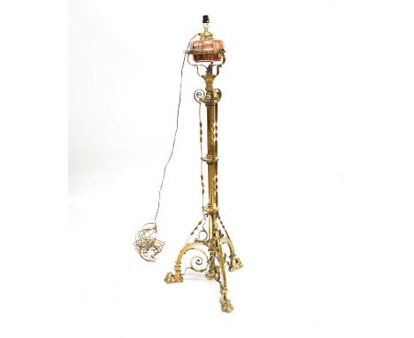 Victorian wrought brass floor standing lamp of Arts and Crafts design with a telescopic column supporting copper reservoir.he