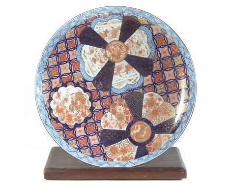 Large Japanese Imari Charger, finely painted with fish and floral devices, late 19th century, with wood stand.62cm diameterCo