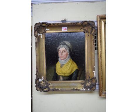 British School, circa 1825, bust length portrait of a seated lady wearing a lace bonnet and yellow scarf, oil on panel, 29.5 