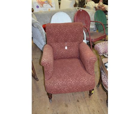 A Victorian mahogany and button upholstered tub armchair.