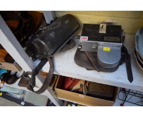 Two vintage bus conductor's ticket machines, one inscribed 'Ultimate Bell Punch Company'; together with a related leather bag