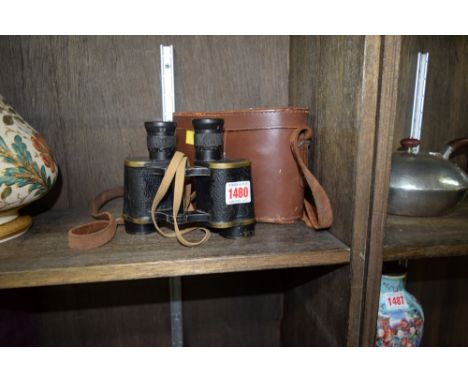 A pair of brass binoculars, with broad arrow, in case. 