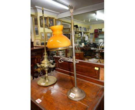 An unusual brass adjustable candle lamp, with opaque glass shade, 52cm high.