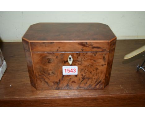 A George III burr yew wood and line inlaid tea caddy of chamfered rectangular form, 19cm wide. 