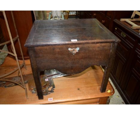 An old oak hinged top commode, 52.5cm wide.  Condition Report: Looks to have been altered  [no interior].  Top slats parting,