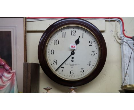 A mahogany framed Smith's circular wall clock, the 12 inch painted dial with broad arrow and dated 1951.