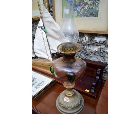 An Art Nouveau brass and coloured glass oil lamp; together with another brass oil lamp.