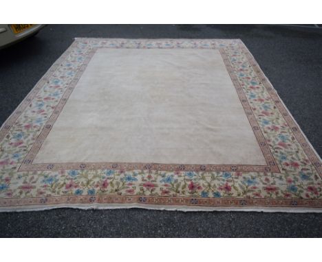 An unusual Kerman style carpet, plain filled centre with corner decoration and large floral border, 3,28m x 2.75m. Condition 