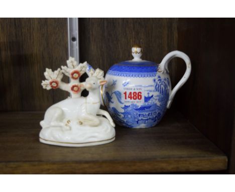 A Copeland Spode blue and white teapot and cover; together with a Staffordshire porcelaneous recumbent deer. 