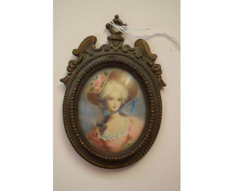 A portrait miniature of an elegant lady, 6.6 x 5.4cm, oval, in a cast brass frame.