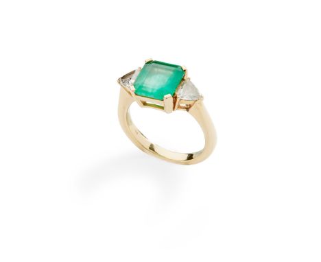 An emerald and diamond three-stone ring claw-set with a square emerald-cut emerald, flanked to either side by a trilliant-cut