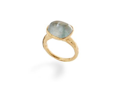 A sapphire ring collet-set with a pale blue cabochon sapphire, the band with planished finish, modelled in 22ct gold(Ring siz