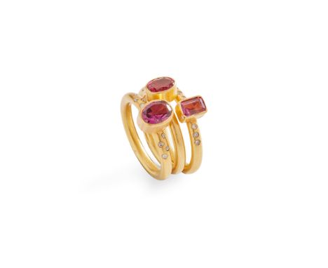 A set of three pink tourmaline and diamond stacking rings each collet-set with an oval or emerald-cut pink tourmaline, two ri