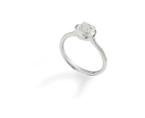 A diamond ring claw-set with a single round brilliant-cut diamond in a stylised floral setting, each shoulder set with small 