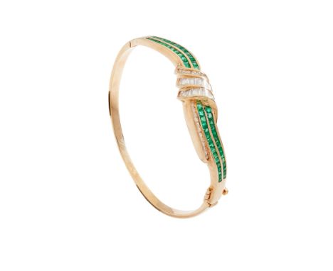 An emerald and diamond bangle of hinged design, channel-set with two rows of square step-cut emeralds, with baguette and roun