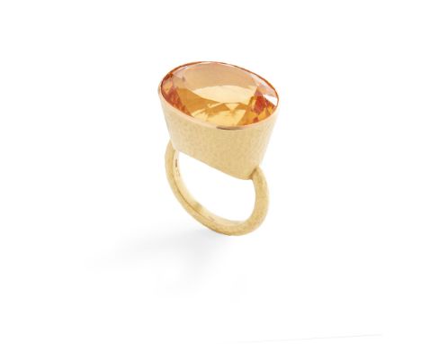 A citrine cocktail ring collet-set with an oval-cut citrine, the setting and band with planished finish, modelled in 18ct gol