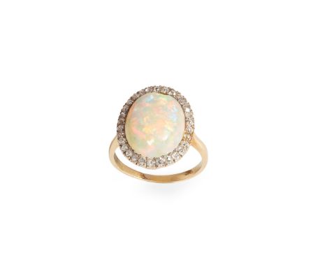 An opal and diamond cluster ring claw-set with an oval cabochon opal in a border of round-cut diamonds, to a plain band, stam