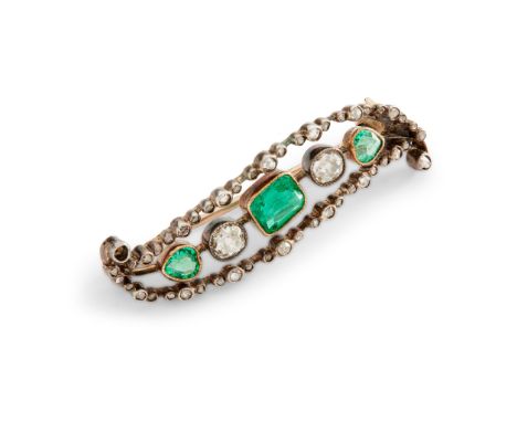 An emerald and diamond brooch millegrain-set with three step-cut emeralds and two cushion-cut diamonds, in a rose-cut diamond