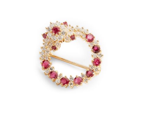 A ruby and diamond brooch claw-set with eight round-cut rubies between pairs of small round brilliant-cut diamonds, the flora