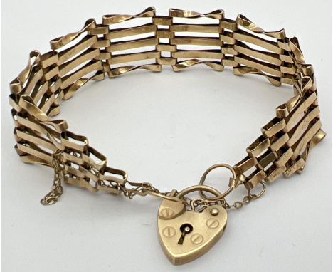 A 9ct gold 5 bar gate bracelet with heart shaped padlock clasp and safety chain. Fully hallmarked to reverse of padlock, with