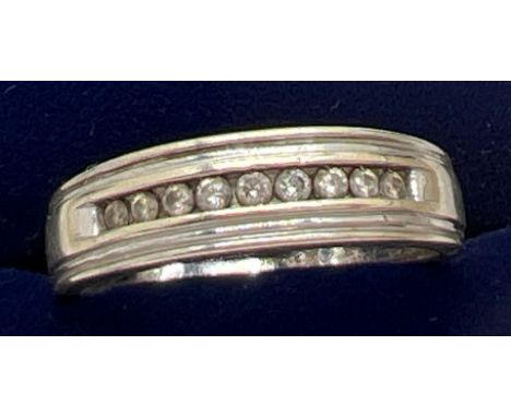 A men's 9ct white gold and .25ct channel set diamond ring. Total weight 4.6g. Size U. Slight miss - shape to base of band. 