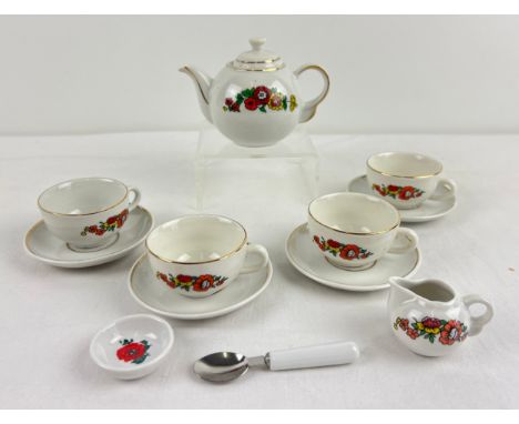 A vintage ceramic dolls teaset with floral decoration. Comprising. 4 cups and saucers, sugar bowl, milk jug, teapot and a spo