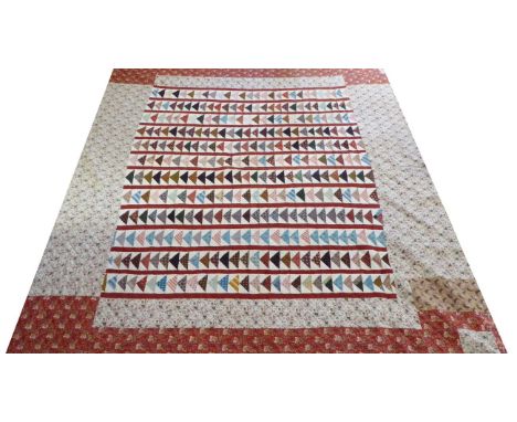 Early 19th Century Pieced Quilt in the Flying Geese Pattern, predominant colours of cream and dark red, inter-spaced with blu