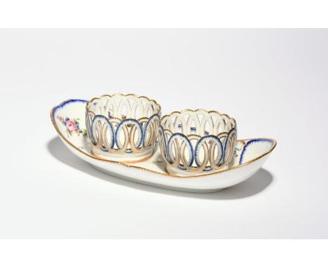 A Sèvres cruet stand (porte-huilier a carcasses)  c.1770-80, the navette shaped stand painted with small polychrome flower sp