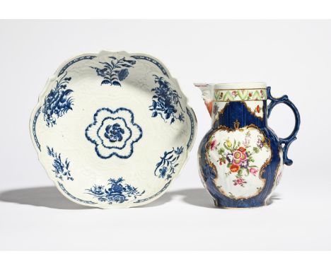 A Worcester mask jug c.1765-70, painted with panels of polychrome flowers reserved on a blue ground, square seal mark, and a 