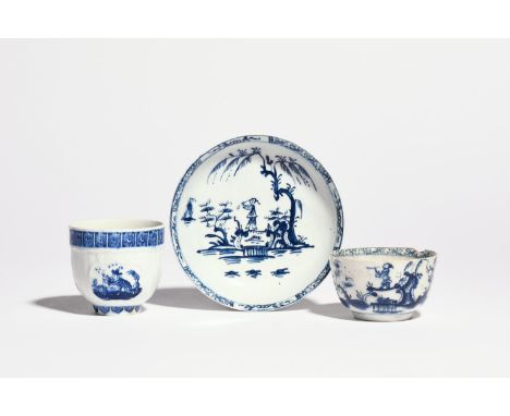 A Lowestoft blue and white teabowl and saucer  c.1770, painted with a Chinese musician crossing a small bridge between gnarle