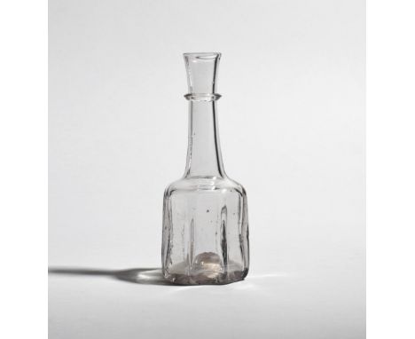 A small cruciform glass serving bottle or decanter  c.1740, the squat heavy body rising to a slender neck with applied neck r