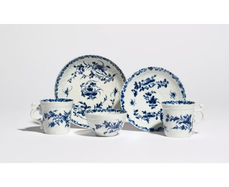 A Worcester blue and white trio  c.1755-58, comprising a teabowl, coffee cup and saucer, moulded and painted in the Feather M