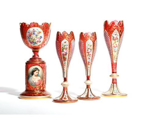 A part garniture of four Bohemian glass vases  19th century, one with a cup-shaped bowl raised on a pedestal base, applied wi