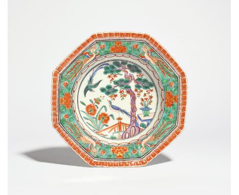 A Worcester octagonal soup plate  c.1780, after a Chinese famille verte original, painted with a bird perched upon a fencepos