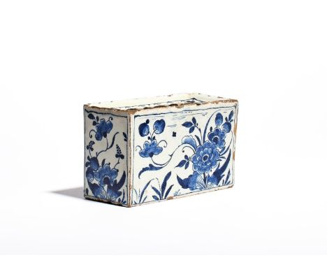A delftware flower brick  c.1760, the rectangular form painted in a deep blue with flowering peony plants, the recessed top p